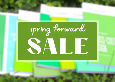 Blurred photo of green books on green grass, with an overlay of text that says: Spring Forward Sale.