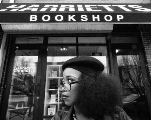 Woman in front of Harriett's Bookshop