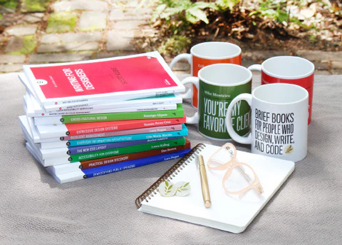 Books, a notepad and mugs.